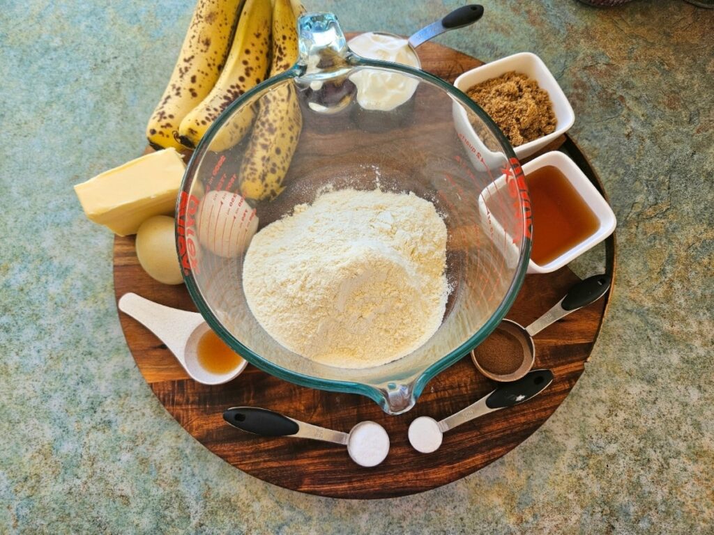 Banana bread ingredients on a cutting board.