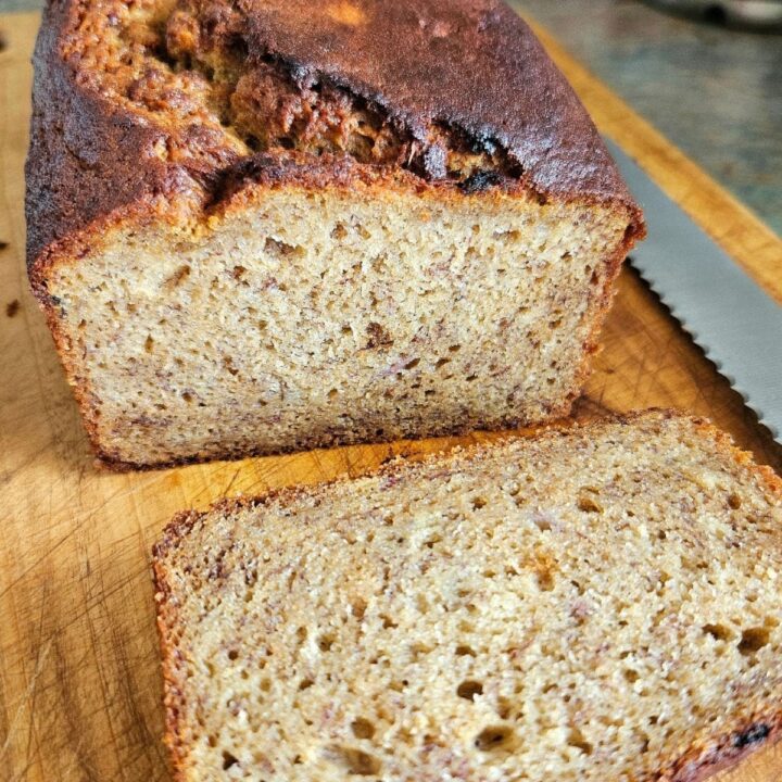 Soft, sliced banana bread on a cutting board.