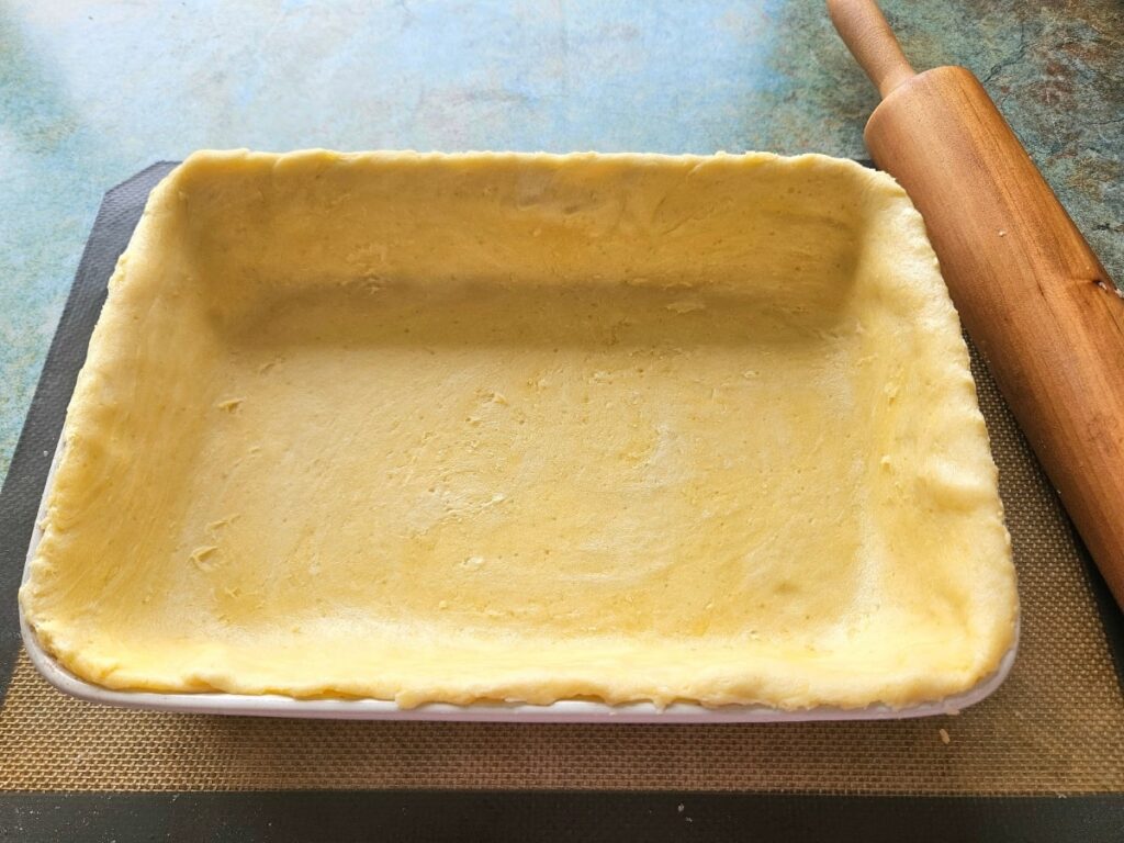 Homemade sourdough discard pie crust ingredients a baking dish ready to be baked.