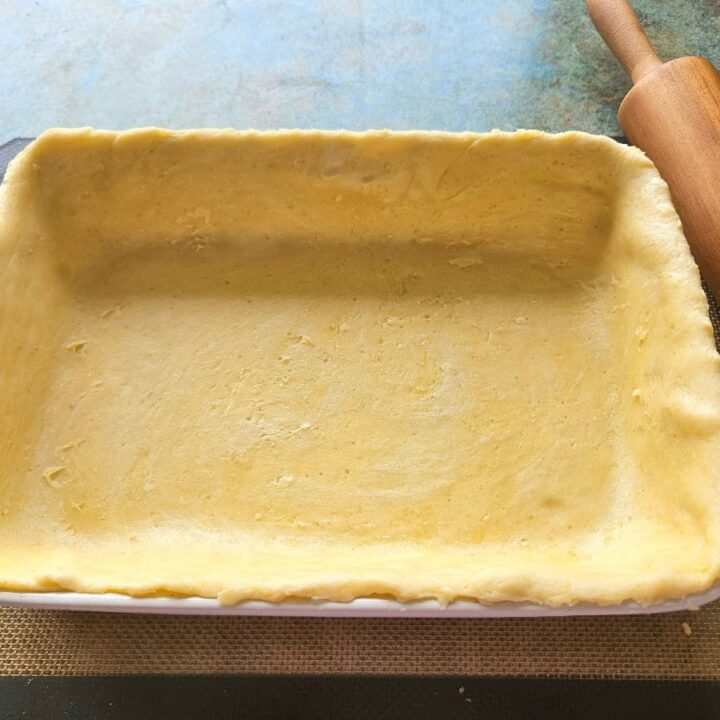 Homemade sourdough discard pie crust ingredients a baking dish ready to be baked.