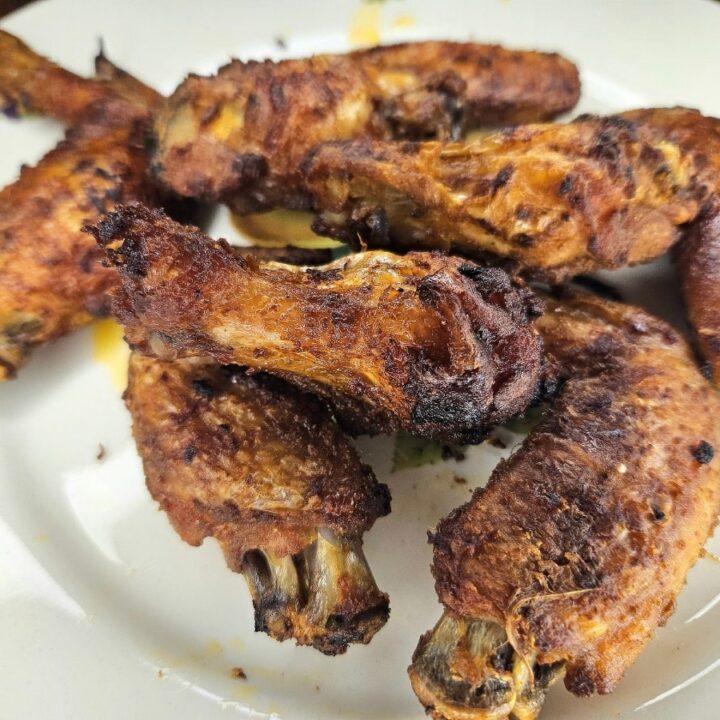 Baked crispy chicken wings served on a dish.