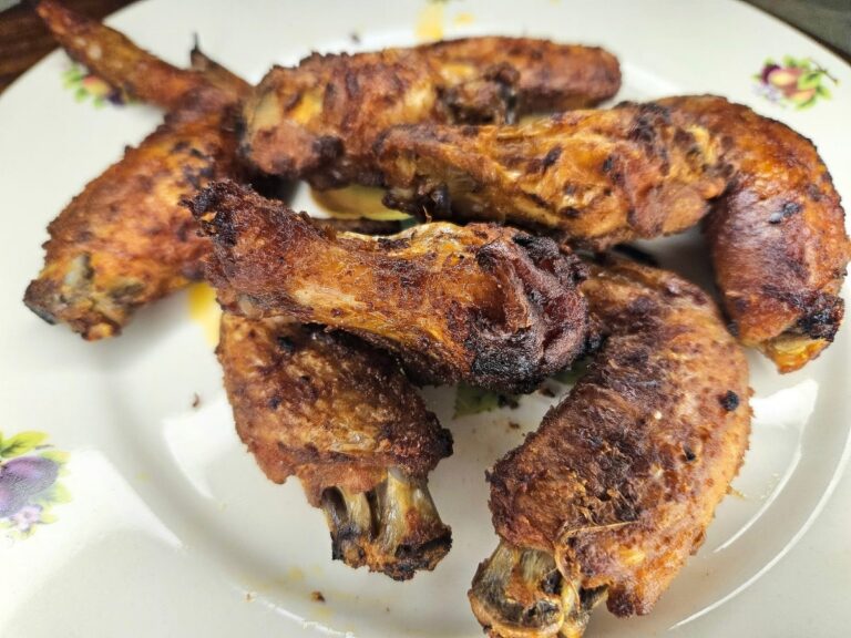 Baked crispy chicken wings served on a dish.
