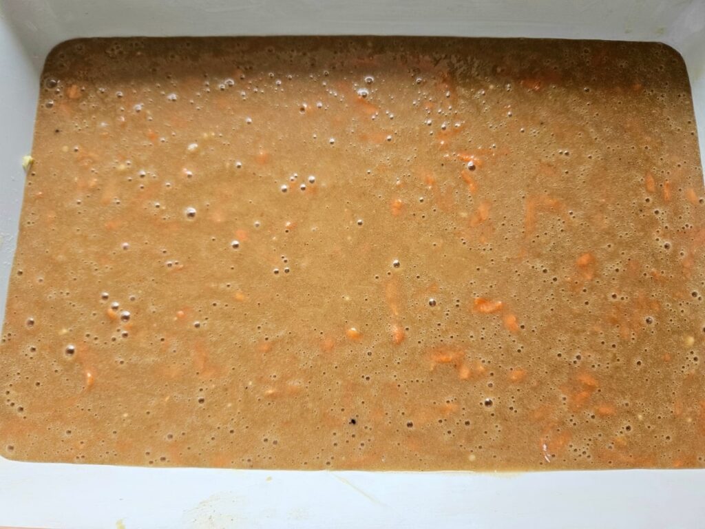 Carrot cake batter in a baking tray.