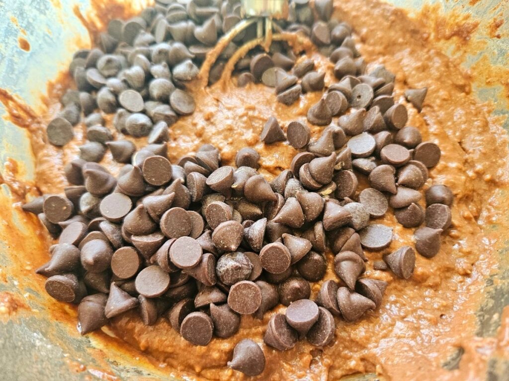 Mixing ricotta chocolate muffin batter in a bowl.
