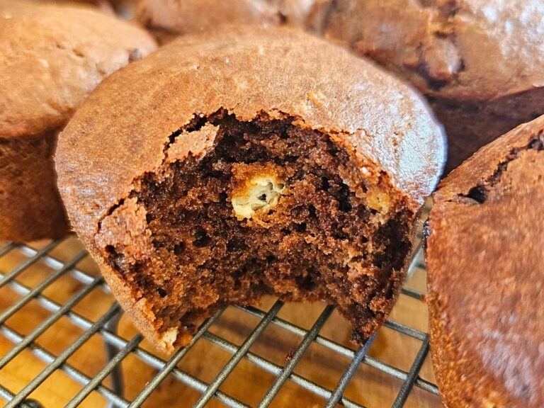 Moist ricotta muffins cooling on a cooling rack.