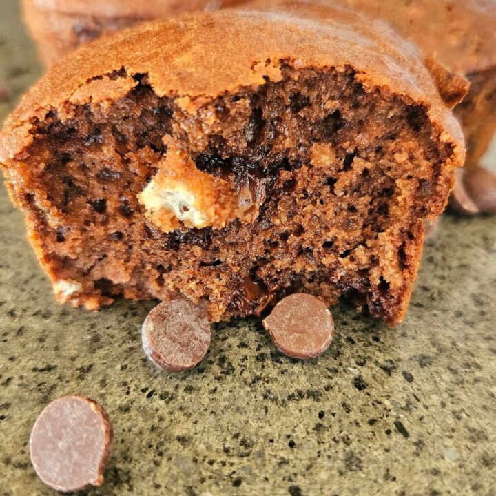 Moist healthy protein chocolate muffin on a cutting board.