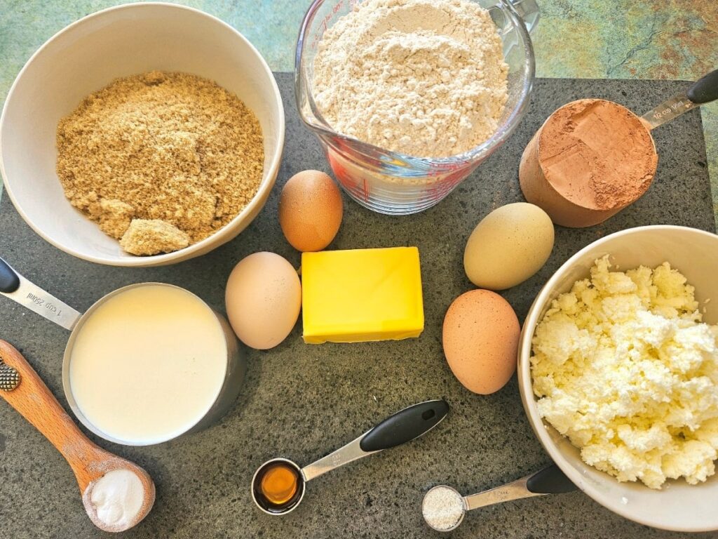 Ricotta chocolate muffin ingredients on a cutting board.