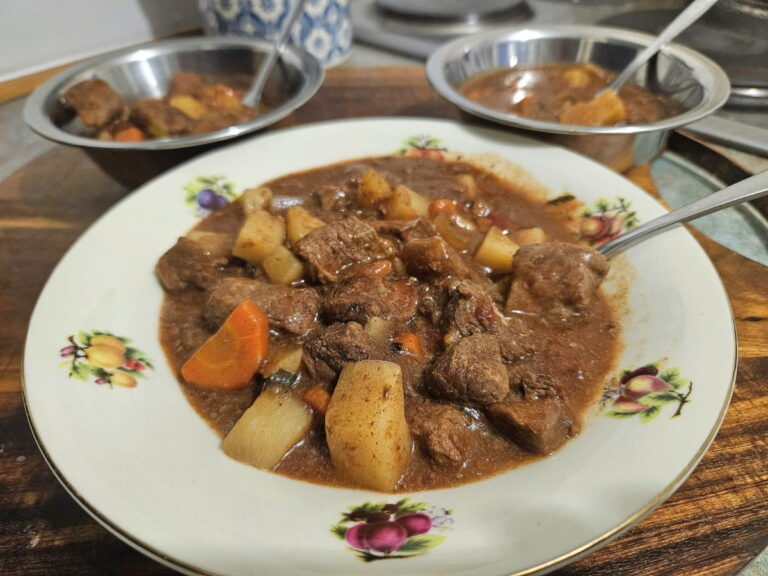 Beef stew poured into 3 bowls.
