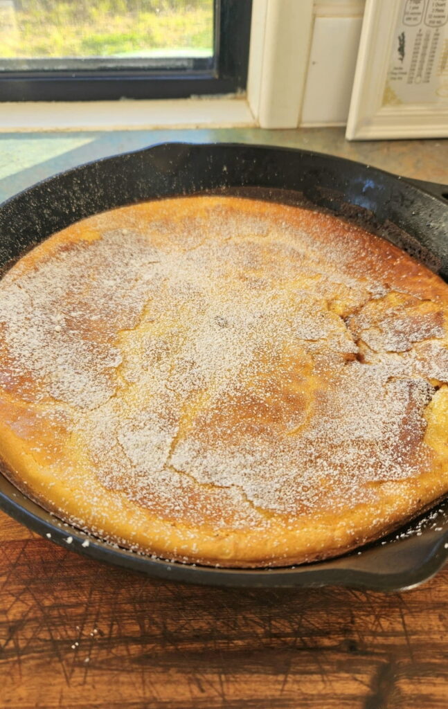Fluffy german pancake in a cast iron pan.