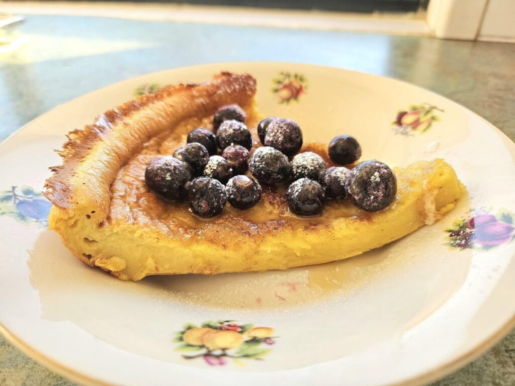 Sourdough german pancake in a bowl topped with blueberries.