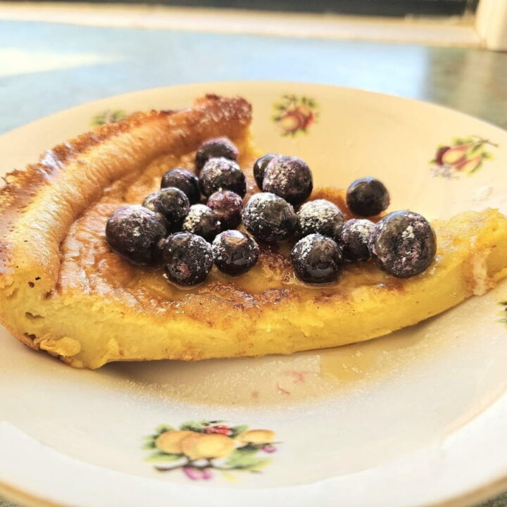 Sourdough german pancake in a bowl topped with blueberries.