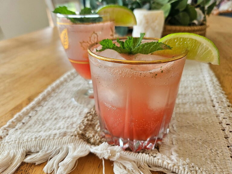 Watermelon lime soda in glass cups with peppermint leaves on top.