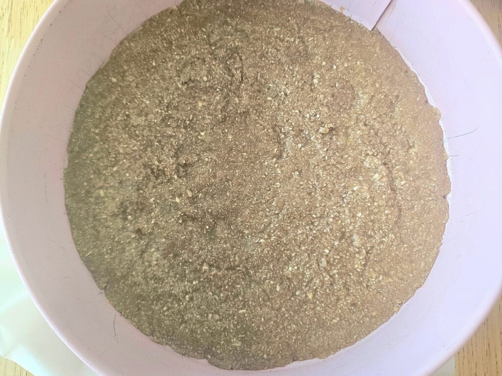 Oat pie crust in a cake pan.