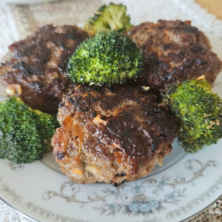 Homemade rissoles on a plate with broccoli.