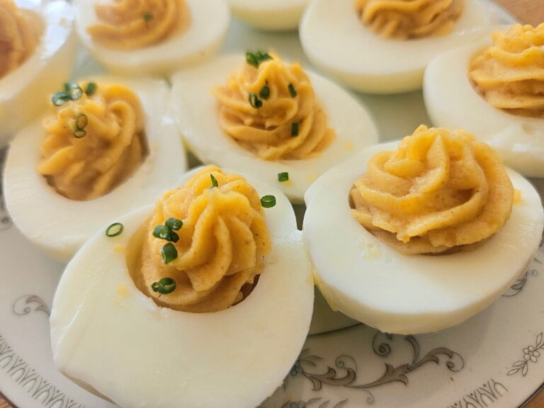 Deviles eggs served on a plate on a table.