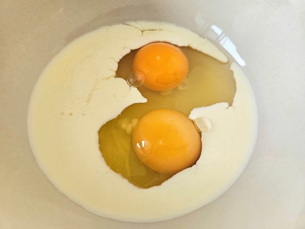 Eggs and cream in a bowl.